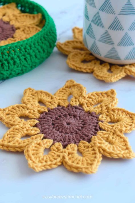 Mae's Flowers Crochet Patterns Roundup · Jo's Crafty Hook Crochet Plate Mat Free Pattern, Crochet Coaster Holder Free Pattern, Small Cotton Crochet Projects, Worsted Yarn Crochet Patterns, Crochet Coasters With Holder, Practical Crochet Ideas, Funny Crochet Patterns, Diy Crochet Coasters, Sunflower Coasters