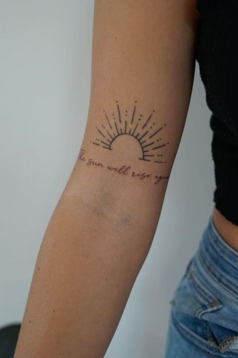 Discover 30 aesthetic tattoo ideas for women featuring delicate and minimalist designs. ✨🌸 #AestheticTattoos #MinimalistTattoos #DelicateInk #TattooIdeasForWomen #SimpleTattoos #TattooInspo #TinyTattoos #ElegantDesigns #ChicInk #TattooTrends2024 The Sun Will Still Rise Tattoo, Still I Rise With Sun Tattoo, Sunrise Tattoo With Words, Sunshine Name Tattoo, Sun Name Tattoo, The Sun Also Rises Tattoo, Suns Gonna Rise Tomorrow Tattoo, Cover Me In Sunshine Tattoo, Sun Bicep Tattoo