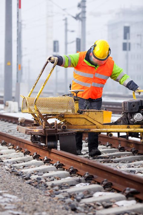 Repair the railtrack. A railroad worker grinds the rails with his machine #Sponsored , #ad, #Ad, #railtrack, #rails, #machine, #railroad Railroad Worker, Machine Image, Realistic Watercolor, Winter Images, Heavy Equipment, Dream Life, Stock Images, Repair, Train