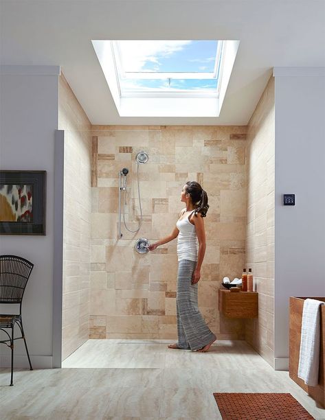 Woman looking up at an open skylight above a modern-looking shower. Bathroom Window Ceiling, Bathroom With Ceiling Window, Shower Skylight Ideas, Skylight Bathroom Ideas, Skylight Shower Ideas, Bathroom Skylight Ideas Ceilings, Shower With Skylight Above, Stairwell Skylight, Bathroom Skylight Ideas