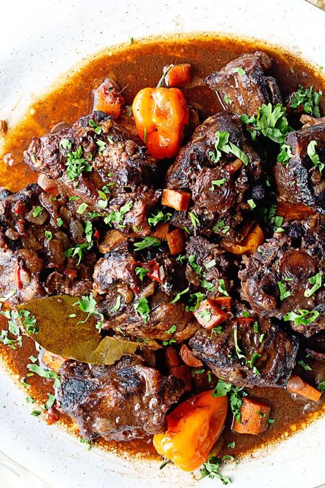 Delicious braised oxtails recipe stewing over the stove Oxtails Recipe, Beef Oxtail, Oxtail Recipe, Jamaican Oxtail, Braised Oxtail, Oxtail Stew, Oxtail Recipes, Trini Food, Jamaican Dishes