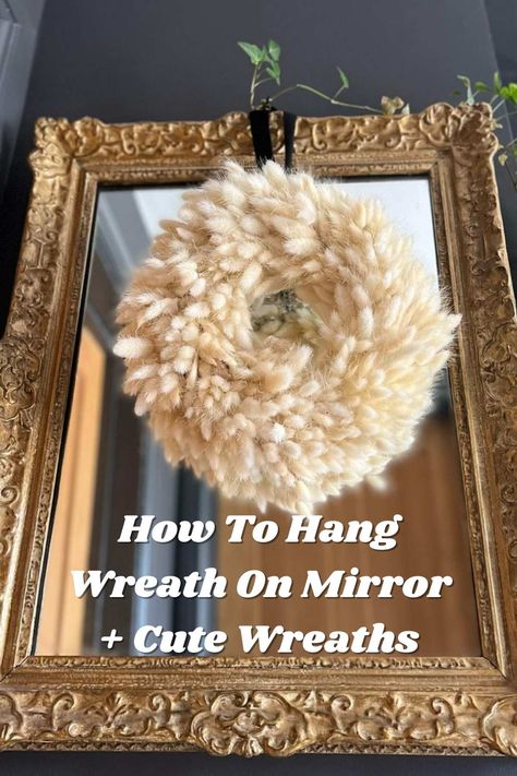 How To Hang Wreath On Mirror + Cute Examples - Pink Pop Design Mirrors With Wreaths, Christmas Wreath Over Mirror, How To Hang Garland On Mirror, Mirror Wreath Decor, How To Hang Wreath On Mirror, Wreath On Mirror Ideas, Wreath On Mirror Christmas, How To Decorate A Mirror For Christmas, Christmas Wreath On Mirror