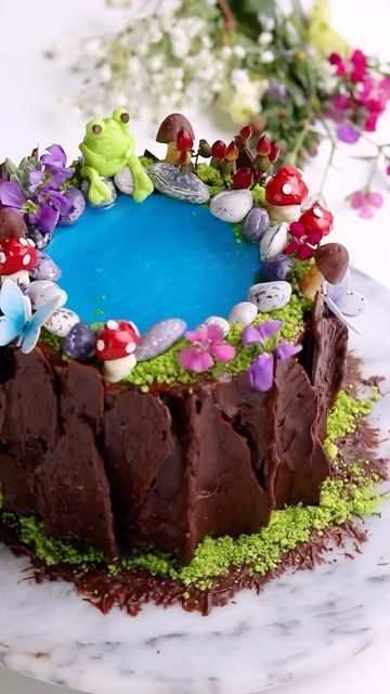 Sheri Wilson on Instagram: "Fairy Pond 🍄 Another variation on the Enchanted Forest Cake tutorial from my book Caketopia (available now on amazon) I’ve had the idea of a fairy pond cake floating around in my head for awhile, and thought using jello would be perfect addition! I added edible glitter to it before pouring onto the cake, and it was magical! 🤩 Some tips for adding jello to your cake -Frost the area with buttercream and chill until firm to the touch before pouring in the jello. -Mak Enchanted Forest Cake, Waterfall Cake, Fairy Pond, Pond Cake, Learn Cake Decorating, Jello Cake, Forest Birthday, The Enchanted Forest, Jelly Cake