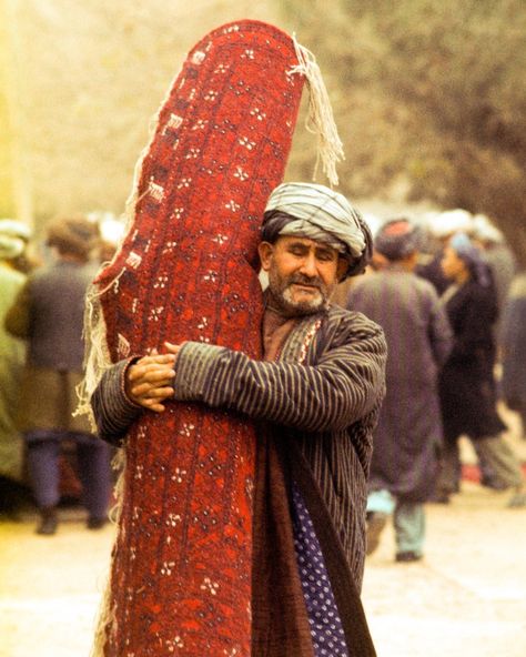 In Balkh Afghanistan a man brings to market a carpet that his wife and children have woven. A large carpet like this one takes many months to complete. Photo from my book #VanishingAsia #Afghanistan #Balkh #carpet Balkh Afghanistan, Flowers Photography Wallpaper, February 3, Large Carpet, Photography Wallpaper, Flowers Photography, A Man, Carpet, Bring It On