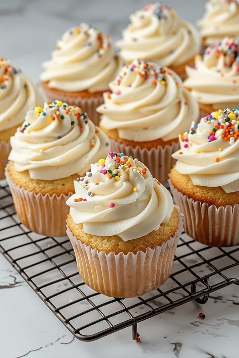 These vanilla cupcakes are simple, sweet, and satisfying! With a luscious buttercream frosting, they're perfect for any occasion. Vanilla Cupcake Topping Ideas, Cupcake With Frosting, Broma Bakery Vanilla Cupcakes, Cakes And Cupcakes Designs, Tasty Cupcakes, Vanilla Cupcakes Decoration Ideas, 4 Cupcakes, Cupcake Recipes Decorating, Muffin Cupcakes