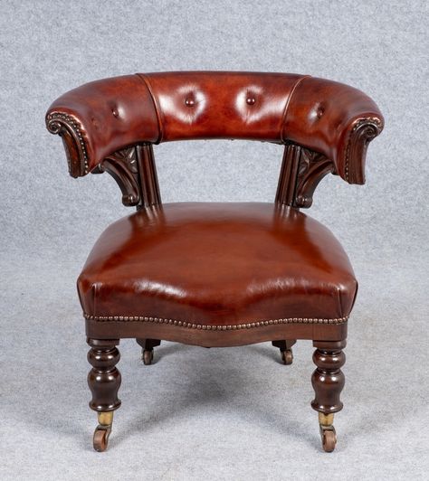 A good Victorian library chair. The mahogany frame having 2 shaped and carved supports with horseshoe-shaped back. The stuff over sprung seat raised on good quality turned legs with brass and pot casters. The whole upholstered in a good quality brown hide with buttoned back and brass studded edging. Dimensions:- Max. Height..28’’/ 71cm. Seat Height..17’’/ 43cm. Depth..26.5’’/ 67.5cm. cm. Width..28.5’’/ 72.5cm.... Antique Desk Chair, Classic Chair Design, Victorian Library, Georgian Furniture, Library Chair, Desk Chairs, Antique Desk, High Table, Antique Chairs