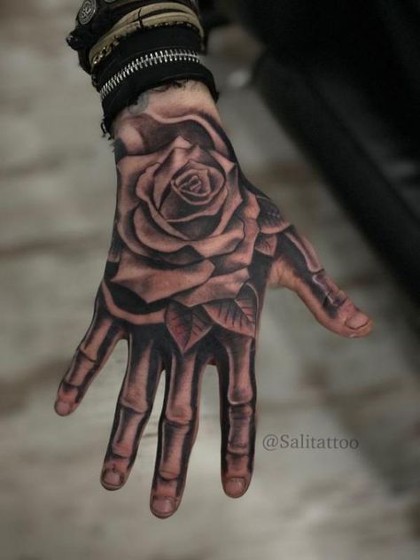 Rose hand tattoo with skeleton fingers Rosen Tattoo Mann, Mens Face Tattoos, Bone Hand Tattoo, Rosen Tattoo Frau, Herren Hand Tattoos, Full Hand Tattoo, Skeleton Hand Tattoo, Tato Jari, Skull Hand Tattoo