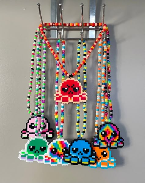 "An octopus reversible pendant kandi necklace is the perfect gift or addition to your rave/festival wardrobe - Double-sided for whatever your mood is! HIGHLIGHTS: ⭐️ Shiny, bright and colorful ⭐️  Reversible/double-sided ⭐️ High-quality & durable ⭐️ One-of-a-kind, unique design ⭐️ Includes FREE GIFTS! ⭐️ Handmade with PLUR ⭐️ Eco-friendly packaging & shipping DIMENSIONS: 25\" chain  Pendant- 3\" tall x 4\" wide Everything in my shop is hand-made and are all original designs! Made with high-quality beads, thick elastic jewelry string (1.2mm), and triple-knotted, ensures the best stretch and durability without drying out over time.  Supporting my small business means the world to me so as a thank you to my amazing customers, every order also includes free gifts! (Bigger orders = bigger gifts Cute Pearler Beads Designs Ideas, Rave Fuse Beads, Rave Necklace Kandi, Perler Necklace Ideas, Rave Perler Bracelets, Fuse Bead Patterns Rave, Kirby Kandi, Perler Beads Ideas Rave, Lost Lands Perler Pattern