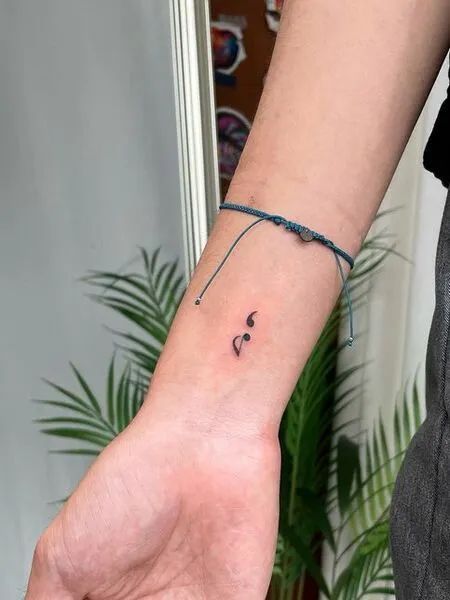 35 Best Meaningful Semicolon Tattoo Ideas - Tattoo Pro #tattooideas #tattooideasforgirls #tattooideasforguys #womenstattoo #tattoodesign #tattoostyle Eight Note Tattoo, Semi-colon Tattoo With Music Note, Music Note And Semicolon Tattoo, Paw Print Music Note Tattoo, Cute Tattoos Music, Rest Note Tattoo, Music Based Tattoos, Music And Semicolon Tattoo, Music Tattoo Wrist