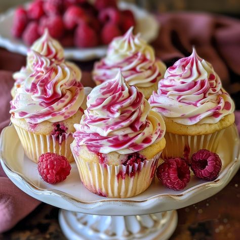 Indulge in the delightful sweetness of summer with these raspberry swirl cupcakes. Each bite is a perfect balance of moist vanilla cake and tangy raspberry swirls, topped with a creamy frosting. Whether you're hosting a summer party or simply craving a delicious treat, these cupcakes are sure to brighten your day! Kitchen Equipment Needed: Cupcake pan Cupcake liners Mixing bowls Hand mixer or stand mixer Piping bag (optional) Toothpick or skewer Ingredients: For the Cupcakes: 1 1/2 cups all- Gourmet Vanilla Cupcakes, Cupcake Recipes Raspberry, Raspberry Vanilla Cupcakes, Raspberry Swirl Cupcakes, Raspberry Cupcakes Recipes, Unique Cupcake Flavors, Cupcakes Raspberry, Best Vanilla Cupcakes, Raspberry Cupcake Recipes