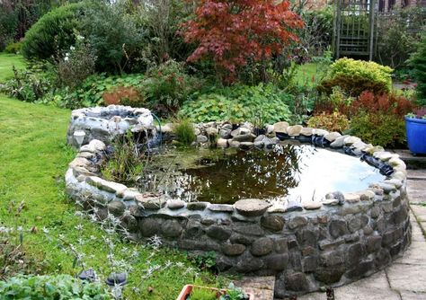 You can use these above-ground koi pond ideas to create something truly beautiful and unique in your backyard. You won't want to stop looking at it! Above Ground Pond, Raised Pond, Building A Pond, Garden Pond Design, Small Pond, Fountains Backyard, Garden Waterfall, Natural Pond, Pond Landscaping