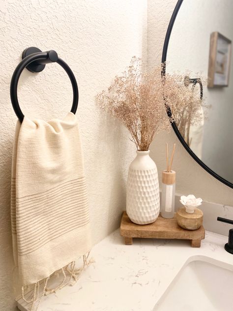 Neutral creamy + wood bathroom decor for spring Small Counter Space Bathroom, Neutral Bathroom Aesthetic, Half Bathroom Decor Minimalist, Toilet Top Decor Ideas, Neutral Apartment Bathroom, Neutral House Aesthetic, Small Bathroom Inspo Aesthetic, Modern Organic Bathroom Decor, Farmhouse Bathroom Sink Decor