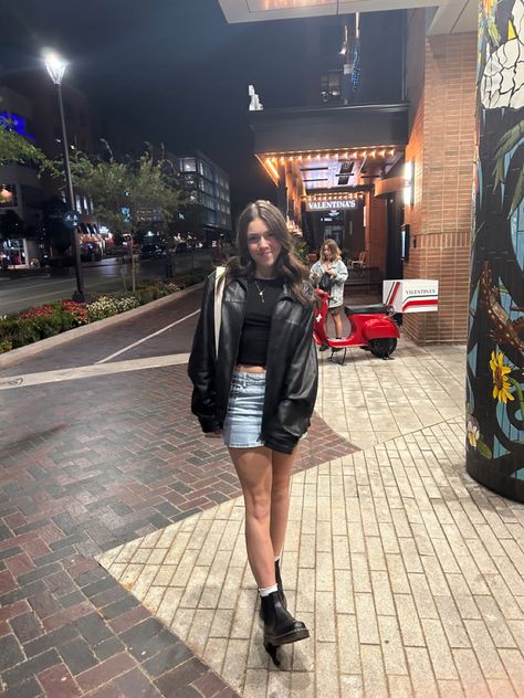 Jean Skirt And Leather Jacket, Leather Jacket Denim Shorts, Jean Skirt Leather Jacket Outfit, Mini Dress Outfits With Jacket, Denim Skirt And Leather Jacket, Jean Jacket Going Out Outfit, Jean Skirt Outfits Concert, Denim Skirt Leather Jacket Outfit, Leather Jacket Jean Skirt