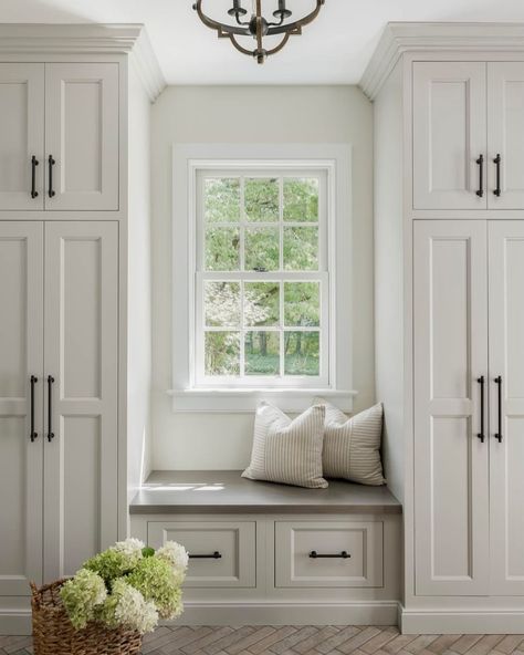 Elevate your entryway with functionality! This chic cream-colored mudroom with soft gray cabinets and a bold entry door makes tidiness look effortless. 🚪✨ Design: @colorandcrownid 📸: @meghanbalcomphotography Cabinetry: @minkrunmillwork Lighting: @visualcomfort Tile: @thetilestudiopa Window Bench With Cabinets, Mudroom Built Ins Around Window, Mudroom Window Bench, Mudroom And Office Combo, Breezeway Enclosed, Pine Mudroom, Mudroom With Window In Middle, Entryway With Window, Mudroom Built Ins With Bench