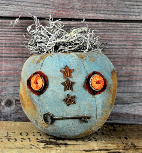 Barb Olson of Muddy Creek Primitives, designer and creator of unique handmade pieces is pleased to offer this one-of-a-kind Jack-O-Lantern. The rusty metal and other old hardware add charm and "primness" to this pumpkin. This JOL is painted aqua blue and grunged up with cinnamon and coffee to look very primitive. It is topped with a real pumpkin stem and Spanish moss. Set several different ones on a bench or mantle with fall garland or grapevine wrapped around them all. Each one of these pumpkins shows its unique personality and is signed by the artist on the base.  He is 4" tall (not including stem). This Jack-O-Lantern is ready for immediate shipment and ready to add prim personality to your Halloween decor! For indoor use only! Aqua Halloween Decor, Vintage Halloween Crafts, Primitive Pumpkins, Pumpkin Show, Primitive Pumpkin, Pumpkin Stem, Fall Garland, Spanish Moss, Rusty Metal