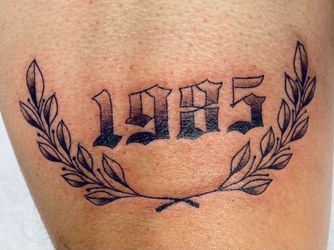 Year tattoo. Laurel wreath tattoo. Above knee tattoo. Eat 1994 Tattoo, 2005 Above Knee Tattoo, Year Tattoo Number Knee, Birth Year Knee Tattoo, Date Of Birth Tattoos Ideas Men, Knee Plant Tattoo, Year Above Knee Tattoo, Year Knee Tattoo, Year Tattoo Above Knee