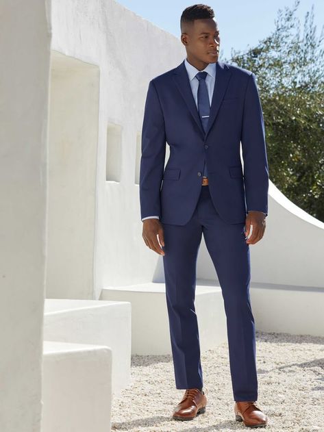 This slim fit suit jacket from Perry Ellis is a stylish and versatile option for any occasion. The dobby fabrication is characterized by miniature geometric patterns woven into the fabric, giving it a unique and eye-catching look. The 4-way stretch provides added flexibility and comfort, while the wrinkle-resistant finish ensures that you'll look your best all day long. 65% Polyester / 28% Viscose / 7% Elastane Slim Fit Dobby Fabrication Is Characterized By Miniature Geometric Patterns Woven I Navy Blue Suit With Blue Shirt, Navy Blue Suit With Light Blue Shirt, Wedding Men Suit Blue, Navy Suit Men's Outfit, Formal Wedding Suits Men, Navy Men’s Suit Wedding, Male Wedding Guest Outfit Formal, Formal Wedding Outfit Men, Men’s Wedding Guest Attire Spring Formal