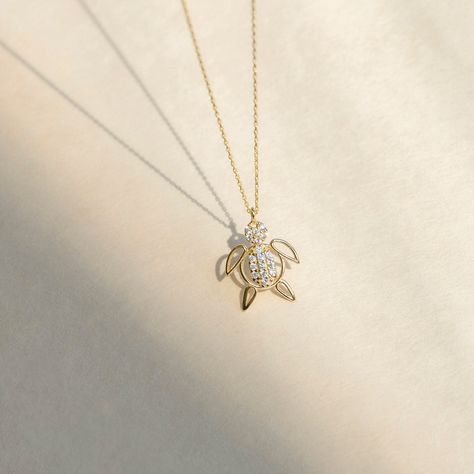 "1- D E S C R I P T I O N Embrace nature's beauty with this 14K Solid Gold CZ Turtle Necklace for Women, featuring a charming turtle pendant adorned with sparkling cubic zirconia stones, adding a touch of elegance and charm to your style. 2- P R O D U C T ∙ F E A T U R E S * Gold material: 14K solid gold * Gold color options: Yellow gold, Rose gold, White gold * Stone: Cubic Zirconia * Choice of chain length: 14\", 16\", 18\", 20\", Pendant Only  * Dimensions:    Pendant Height: 12 mm / 0.47 in Necklace Pendant Design, Cute Pendants, Nature Friendly, Nature Necklace, Solid Gold Necklace, Turtle Necklace, Turtle Pendant, Meaningful Jewelry, 14k Gold Necklace