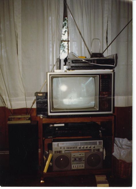 Semi-state-of-the-art home theater set-up, early 1980s. Two VHS decks to copy rental movies. Stereo VCR routed to boombox routed to speakers for "Hi-fi" sound. 19" TV with LCD display. No using the pliers to change channels on this setup! 70s Movie Theater Aesthetic, 1980s Tv Set, Vhs Home Video Aesthetic, Vhs Tv Aesthetic, 80s Tv Aesthetic, Early 80s Aesthetic, Vhs Tv, 1980s Boombox, Movie Theater Aesthetic