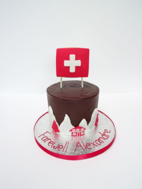 Swiss-themed farewell party cake with fondant snow-capped peaks and ski chalets, topped with a Swiss flag cookie. www.thewhiskandspoon.co.uk Swiss Themed Party, Switzerland Themed Party, Switzerland Decor, Farewell Cake, Leaving Party, Cross Cakes, Swiss Flag, Cake With Fondant, Farewell Party