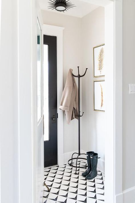 Vestibule with wrought iron coat rack, black and white geometric floor tiles and gold leaf frames illuminated by an oil rubbed bronze sunburst flush mount. White Tile Floors, Black And White Tile, Entryway Tile, Kate Marker Interiors, Entryway Makeover, Entry Tile, Narrow Hallway Ideas, Entryway Flooring, Geometric Floor