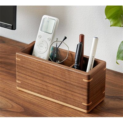 Marketing Strategy: Are you troubled by a cluttered office desk? Say goodbye to chaos with a multi-functional wooden pen holder that frees up space and enhances organization. Crafted from natural wood, finely polished, and durable, it brings a touch of elegance and order to your workspace. | Ivy Bronx Desktop Storage Box, Office Organizer, Miscellaneous Storage Box Brown 3.9 x 7.87 x 3.14 in, Solid Wood | C110738308_2012347231 | Wayfair Canada Cluttered Office, Wood Charging Station, Miscellaneous Storage, Wood Pen Holder, Wood Pencil Holder, Wooden Pen Holder, Small Wood Box, Wooden Ideas, Wooden Desk Organizer