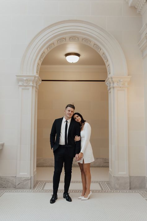 classically stylish couple share a sweet embrace surrounded by beautiful arches and artwork in the Utah State Capitol Building - Poise and Ivy Imagery Places For Engagement Pictures, White Building Photoshoot, Engagement Photos Playing Pool, Utah Capitol Engagements, Florence Italy Engagement Photos, Engagement Photos Capitol, Modern Engagement Photoshoot, State Capitol Engagement Photos, Capital Building Engagement Pictures