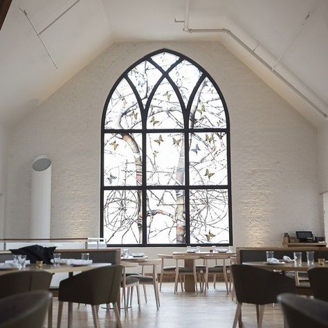 The Preacher’s Son, Bentonville, Arkansas  This modern Southern restaurant is located in a former church—don’t miss the apse that has been reconfigured as the bar—but the redesign, created by FÖDA Studio and Shears Adkins Rockmore, didn’t just rely on the building’s former use. "We updated Gothic Revival to the contemporary experience,” says Jett Butler of FÖDA Studio. Especially striking are the colorful art glasses by George Dombek, a modern twist on traditional stained glass windows. Gothic Restaurant Interior Design, Den Addition, Modern Gothic Architecture, Modern Gothic Interior, Gothic Revival Interior, Gothic Bar, Gothic Living Room, Church Photos, Southern Restaurant