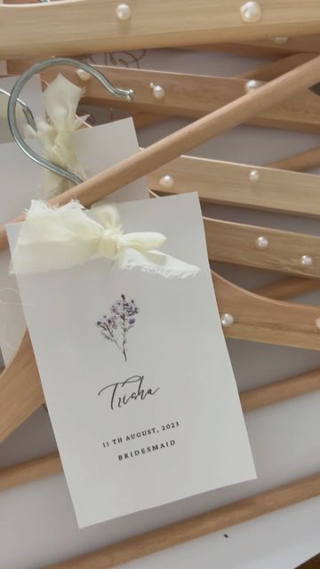 Homebody Creative Co on Instagram: "Easiest diy ever! Grabbed wooden ikea hangers, glued on some pearls, designed in Canva, printed and tied on with ribbon! 💗 ⠀ #weddingideas #weddingplanning #amazonfinds #2023bride #bridetobe #wedding #amazonbride #diybrides #weddinginvitations" Bridesmaid Hangers Diy, Ikea Hangers, Diy Wedding Hangers, Bridal Party Hangers, Bridesmaid Hangers, Bride Hanger, Bridal Hangers, Wedding Dress Hanger, Diy Wedding Dress