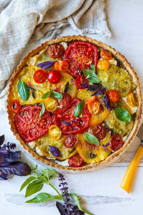 Elegant and savory, this fresh Tomato Tart is made with a flaky olive oil pastry dough and flavorful heirloom tomatoes. A light layer of goat cheese and fresh basil complement, creating flavors and textures that are both satisfying and impressive. Great for a light meal or appetizer. Savoury Pie, Tomato Tart Recipe, Salty Recipes, Feasting At Home, Creamy Goat Cheese, Tomato Tart, Savory Pastry, Heirloom Tomato, Juicy Tomatoes