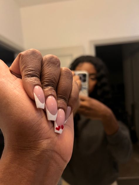 Nail inspo, subtle Valentine’s Day nails, French tips, heart nail designs, French tip acrylic nails. Black girl, nail art, nail inspiration, black woman, nail ideas French Tip Acrylic Nails Black, Black French Tip With Red Heart, Black French Tip Nails With Love Heart, French Tip With Heart Design, French Tips Heart, French Tips With Red Hearts, Nail Inspiration Black, Short Black French Tip Nails Chrome Hearts, Cdg Heart Nails French Tip