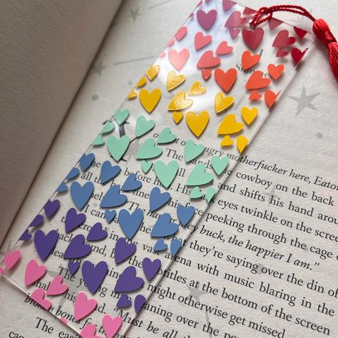 ✨Newness…..✨ How stunning is this new bookmark ? 😍 I am absolutely obsessed with it and I am beyond happy to announce this is now available on my website !! 😍 ��🏷️ #bookmark #booklover #rainbow #bookworm #bookaddict #pride #gaypride #loveislove #rainbowpride #readergifts #readersofinstagram #bookaesthetic #shelfie #gaybookmark #lgbtqplus Homemade Bookmark, Heart Bookmark, Creative Bookmarks, Unique Bookmark, Rainbow Hearts, Cute Bookmarks, Gifts For Bookworms, Acrylic Plastic, Gifts For Readers