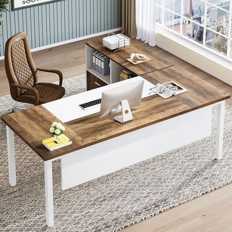 The contemporary L-shaped office desk featuring a white structure with contrasting dark wood accents. It is fitted with a built-in shelf, two drawers, and an additional cabinet with shelves and a wheeled base for mobility. The desk provides a generous workspace and ample storage for a neat and efficient office setup. Home Office L Shaped Desk Layout, Computer Desk Home Office, L Shaped Office Desk, Computer Armoire, Office Furniture Set, Computer Desk With Shelves, Desk Modern, Writing Desk With Drawers, Desk Layout