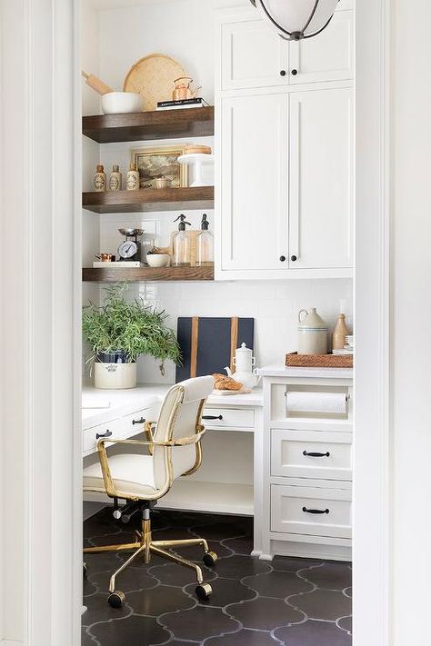 Brown wood floating shelves are stacked over a white built-in pantry desk donning oil rubbed hardware and matched with a white and gold task chair. Painted Brick Backsplash, Grey Painted Cabinets, Craft Nook, Style Me Pretty Living, Brick Backsplash, Tudor House, Butler Pantry, Tudor Style, Butler's Pantry