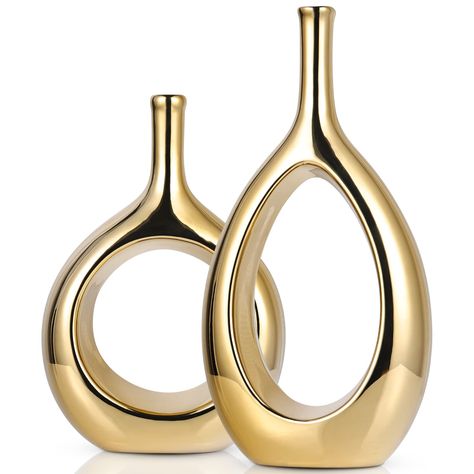 PRICES MAY VARY. 【Glossy Gold Decor Vase】Contemporary home decor is a widely popular mid-Century Modern Ellipse Hollow Vase, These small vases are perfect for your entryway, coffee table, shelf, mantle, accent table, and much more. They will look great no matter the season or Holiday! Create a space in your home with refined Fashion home décor accents, Create a warm atmosphere in your home. 【Modern Gold Vases】Our Light Luxury Ceramic Glossy Gold Vases 2-Piece Set,They come in different shapes an Gold Vase Decor, Small Vases, Gold Centerpieces, Gold Vase, Vase Ceramic, Gold Vases, Luxurious Home, Gold Ceramic, Modern Vase