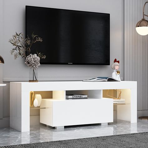 This stylish TV stand is designed to bring a touch of sophistication to your living room. The LED RGB lights system features 16 monochrome and 4 discoloration options, giving you the flexibility to customize the lighting to suit your mood. Tv Stand With Led Lights, Large Tv Stands, Modern Tv Cabinet, Led Tv Stand, White Tv Stands, Modern Entertainment Center, Tv Stand Cabinet, White Tv, Tv Stand With Storage