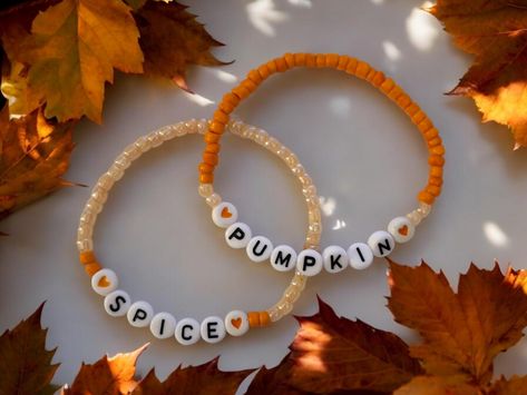 🎃PUMPKIN SPICE handcrafted beaded bracelets.  Fall is on the way and that means  ...yep...pumpkin spice  This is for a set of 2 stretch bracelets made with glass beads and acrylic letter/heart beads.  Wear them alone or stack them with other bracelets.  A perfect addition to a Fall wardrobe. Great gift idea!  If you are buying it as a gift the standard size is 7".  How to measure for a bracelet... Wrap a measuring tape around your wrist at the point where you want to wear the bracelet. If you don't have a flexable measuring tape, use a piece of string, or strip of paper, mark the length, and measure it with a ruler.  Now make sure you add 1/2" to your measurement. Women's Extra Small: 6.5 inches Women's Small: 6.75 inches Women's Standard: 7 Inches Women's Medium: 7.25 Inches Women's Larg Large Beaded Bracelets, Fall Beaded Bracelets Ideas, Pumpkin Spice Bracelet, Small Business Bracelet Ideas, Clay Bead Bracelets Ideas Fall, Cute Bracelet Making Ideas, Fall Seed Bead Bracelets, Fall Braclets Ideas, Cute Fall Bracelets