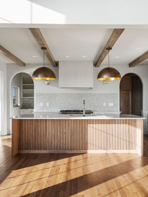 Wooden accents on kitchen islands add texture and color. We love this kitchen island combination with the wooden beams and brass pendent lights. Kitchen Island Paneling Ideas, Wood Slat Kitchen Island, Wood Slat Kitchen, Wooden Island Kitchen, Pendent Lights, Slate Kitchen, Vaulted Ceiling Kitchen, Wooden Island, Light Wood Kitchens