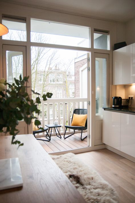 "We're spoilt with the amount of natural light this apartment gets, and with a balcony on every room we get to chase the sun throughout the day." Amsterdam Apartment, White Wicker Furniture, Couples Decor, Wood Lounge Chair, Balcony Design Ideas, Corner Seating, Chicago Apartment, White Tile Floor, Small Outdoor Spaces