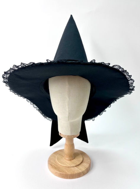 All black witch hat. The base of the hat is black canvas. The Brim of the hat in lined with a stiff black ruffle lace edging. The hat band is a black velvet that shimmers in the light. The black velvet ties in a full bow with pointed diagonal tails that trail off the back edge of the hat. The hat is lined with black satin. Lace Witch Hat, Velvet Witch Hat, Season Of The Witch, Velvet Bow, Lace Edging, Black Ruffle, Witch Hat, Black Canvas, Costume Ideas