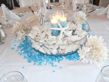 Beach Centerpieces and wedding reception decor with seashell, candles, and aqua jewels Love this underwater idea diy for an aquarium or beach design. Seashell Candle Centerpiece, Beach Wedding Table Settings, Beach Theme Centerpieces, Beach Themed Wedding Decorations, Beach Centerpieces, Beach Wedding Tables, Beach Wedding Centerpieces, Beach Wedding Guests, Beach Candle