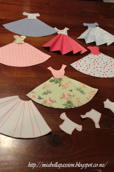 I have always loved these cute paper dresses... and thought I would make a mini bunting of them for my Granddaughter Emilee.   Pattern by Jane CS. is on Mia Bella Passions blog. Jane CS uses her pattern to make the most gorgeous cards.  But I thought they would make a cute bunting.   Cut out the pattern pieces. Use as a template on your pre-chosen pretty papers.   Rules the pleats in pencil.   Cut out the skirt and bodice pieces.   Use  ruler to crease the skirt pleats, and glue bodice… Diy Paper Dress, Make A Paper Flower, Paper Dress Patterns, Bunting Diy, Paper Dresses, Paper Flower Wreaths, Mother Daughter Projects, Paper Towel Tubes, Origami Dress