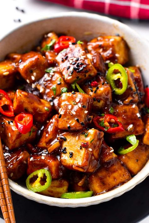 This Szechuan Tofu will fix your spicy Chinese food craving! Delicious crispy tofu pieces coated with a spicy Sichuan sauce packed with garlic, chili pepper, and Schezuan pepper. Tofu Dinner Ideas, Sichuan Pepper Recipes, Spicy Tofu Stew, Chinese Tofu Recipes, Szechuan Tofu, Tofu Szechuan, Spicy Peanut Tofu, Spicy Tofu Recipes, Spicy Tofu Hotpot