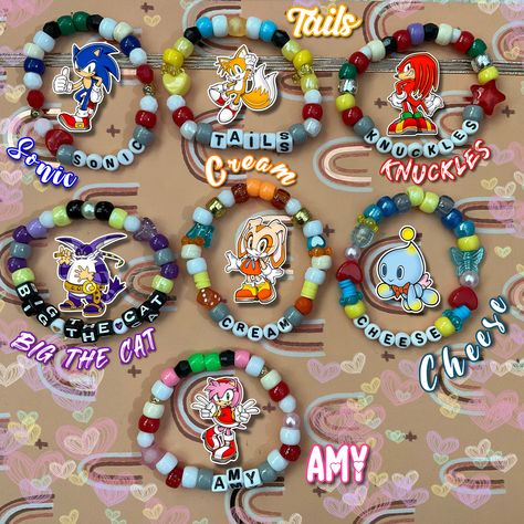 💙Ready for an adventure with Sonic and friends?❤️ Then these bracelets are perfect for you! Each bracelet is stretchy enough to fit an average sized wrist. However, if a bigger or smaller size is needed please contact me. Have any further questions? Please message me and ask! ❗️DISCLAIMER: I own absolutely nothing except for the patterns/designs of these bracelets. I only used the character photos to show what each bracelet is inspired after! All other rights go to their respective owners. It is recommended you don't get these bracelets wet. Trio Kandi Bracelets, Hazbin Hotel Clay Bead Bracelet, Pony Bead Bracelets Patterns, Sonic Bracelet, Bracelet Design Ideas, Sonic Kandi, Character Bracelets, Fandom Beaded Bracelets, Bracelet Patterns Beads