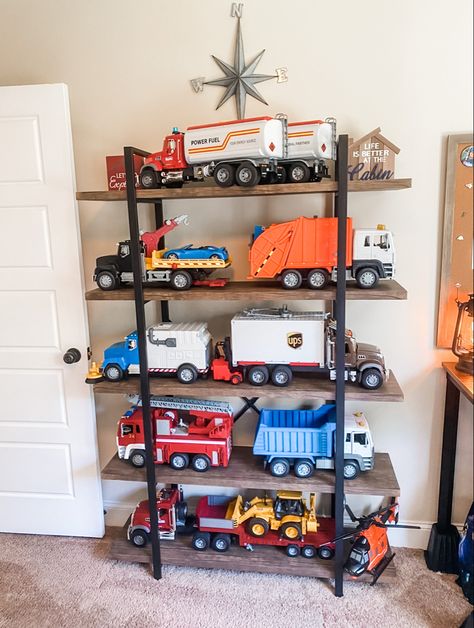 Car Toy Storage Ideas Playroom, Big Truck Toy Storage Ideas, Toy Truck Garage, Organizing Big Toy Trucks, Playroom Truck Storage, Big Toy Car Storage Ideas, Toy Truck Garage Storage, Truck Storage Ideas Toy, Big Truck Toy Storage