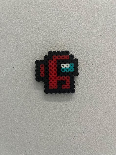 This is a small Among Us design made of Perler beads with a keychain! Customizable colors! Tiny Hama Bead Designs, Perler Bead Patterns Among Us, Dungeons And Dragons Perler Beads, Hama Beads Small Patterns, Cute Melting Bead Ideas, Iron Bead Art, Cross Perler Beads, Small Perler Ideas, Small Hama Bead Designs