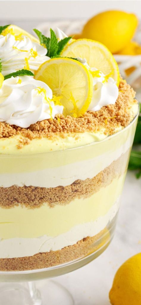 Lemon lush trifle is fluffy, light, and airy - perfect for summer potlucks and parties! #amandascookin #triflerecipes #easydesserts Lemon Lush Trifle, Desserts With Graham Cracker Crumbs, Summer Trifle Desserts Easy, Lemon Pretzel Dessert, Graham Cracker Crumb Recipes, Dessert Trifle, Lemon Trifle, Lemon Lush Dessert, Trifle Bowl Recipes