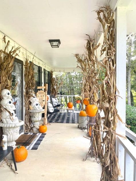 20 Blended Fall and Halloween Decor Ideas » Lady Decluttered Corn Stalk Porch Decor, Corn Stalk Decorations Front Porches, Decorating With Corn Stalks, Corn Stalks Front Porch, Fall And Halloween Decor Ideas, Corn Stalks Decorations, Fall Mailbox Decor, Corn Stalk Decor, Fall Festival Decorations