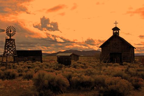 Image chosen to depict possible environmental features/decoration, here a windmill and a church and outhouses. Wild Western Aesthetic, Gothic Western Wallpaper, Wild West Women Aesthetic, Retro Cowboy Aesthetic, Old West Aesthetic, Wild West Buildings, Dark Western, Dnd Aesthetic, Gothic Western