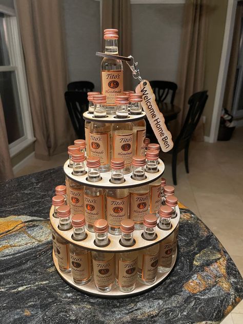 This shot cake tower holds 36 mini bottles of Fireball or Titos. 50 ml of either.  Makes a great gift for the hard to shop for person or to display at an event like wedding or birthday.  These are the mini bottles. Not full size.  The fireball bottles need to be slightly turned to fit.  See pictures. Four layers 17 on bottom, 12 on next level, then 6 and one to top it off and create the fourth level. This works with fireball and any TALL narrow bottles like tifos or grey goose. Does not work for patron or absolute and they are smaller squattier bottles.  Made of plain unfinished wood. You can paint this if you want to add color. Custom engraved fun little keychain and bottle neck ring included. These are made out of the same unfinished wood. Just a cute little add on to make this item cust Vodka Themed Party Ideas, Shot Bottle Gift Ideas, Alcoholic Gift Baskets, 21 Birthday Cake For Him, Funny Birthday Gifts For Women, Diy 21st Birthday Gifts For Her Baskets, Airplane Bottles Liquor Gift Ideas, Birthday Ideas For Adults Women, Liquor Themed Birthday Party